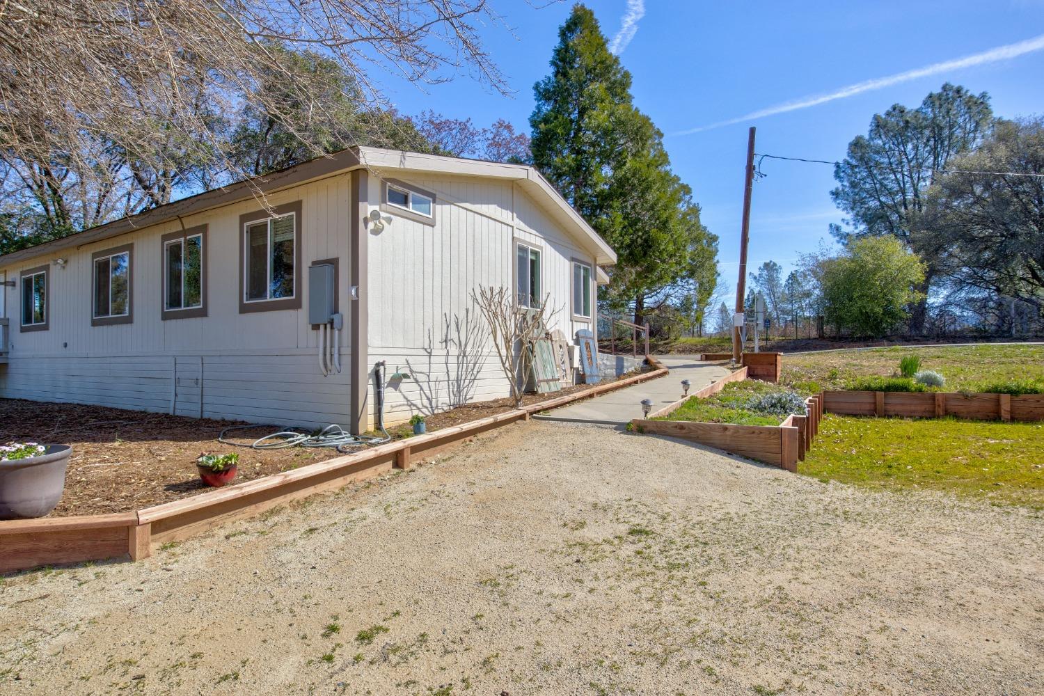 Undisclosed Address Somerset, CA 95684 - Photo 20 of 90 a view of backyard with large tree and wooden fence