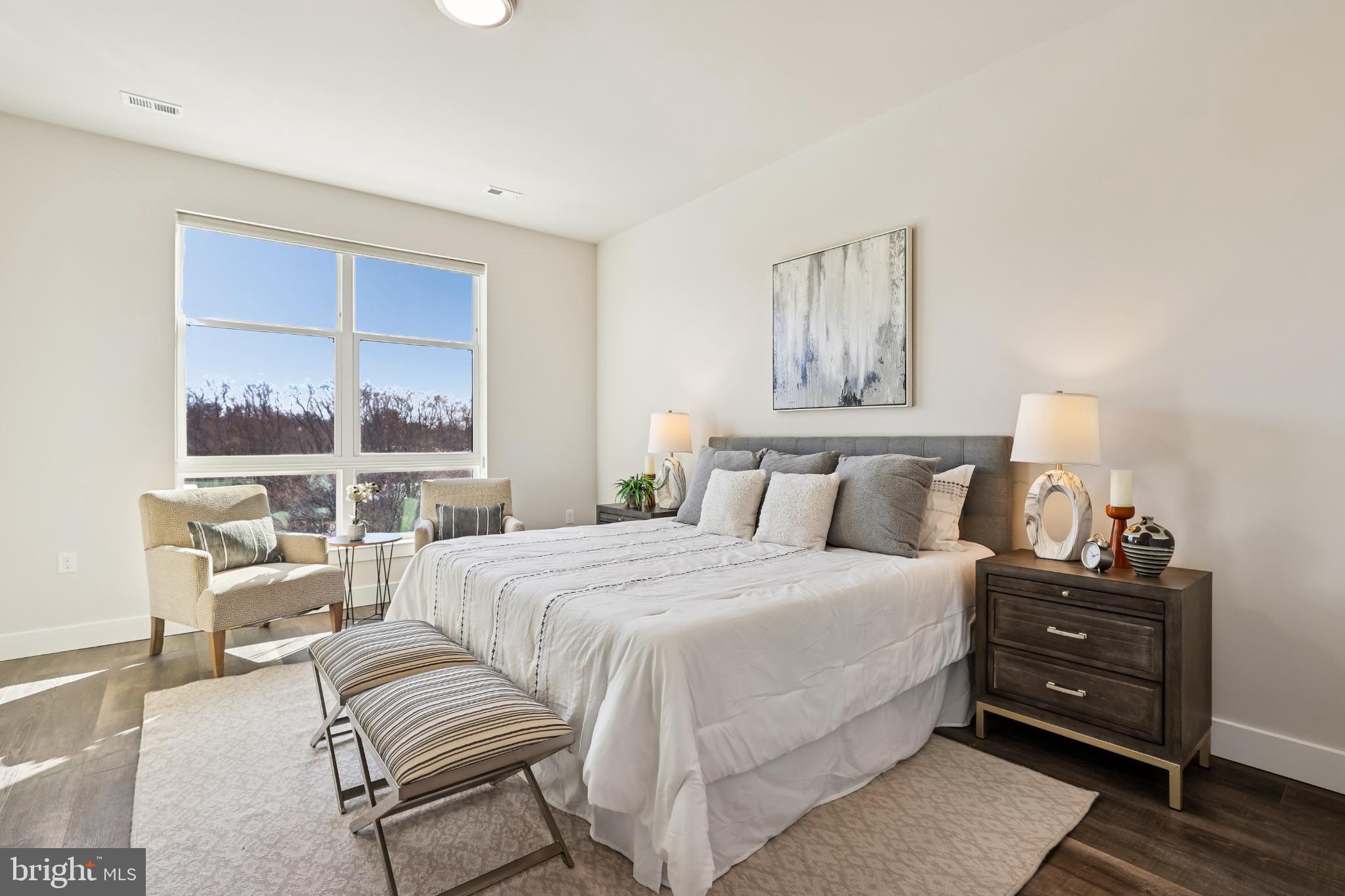 1761 Old Meadow Road, Unit 517 McLean, VA 22102 - Photo 11 of 39 a bedroom with a bed and wooden floor