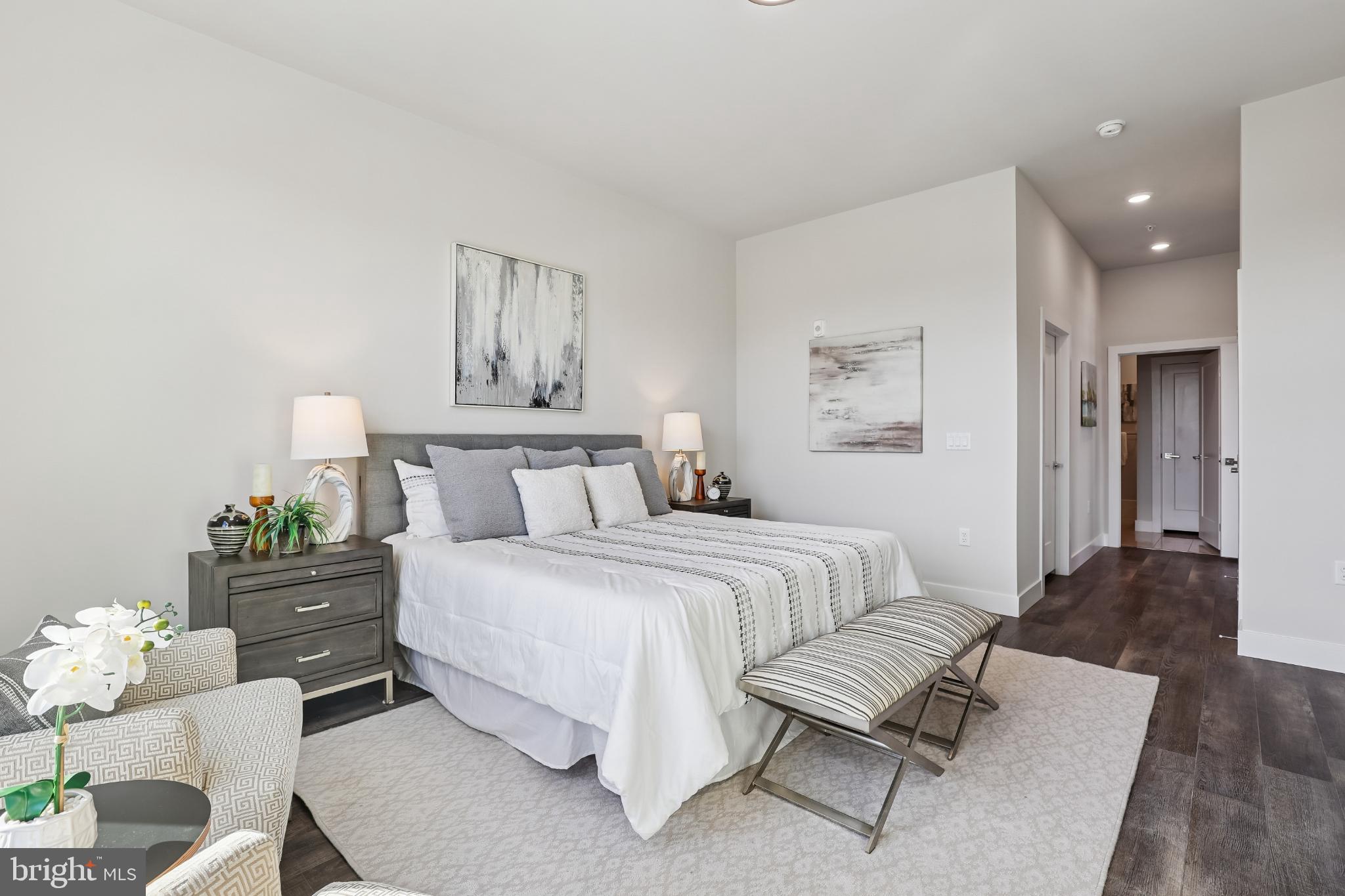 1761 Old Meadow Road, Unit 517 McLean, VA 22102 - Photo 13 of 39 a spacious bedroom with a bed and cabinet
