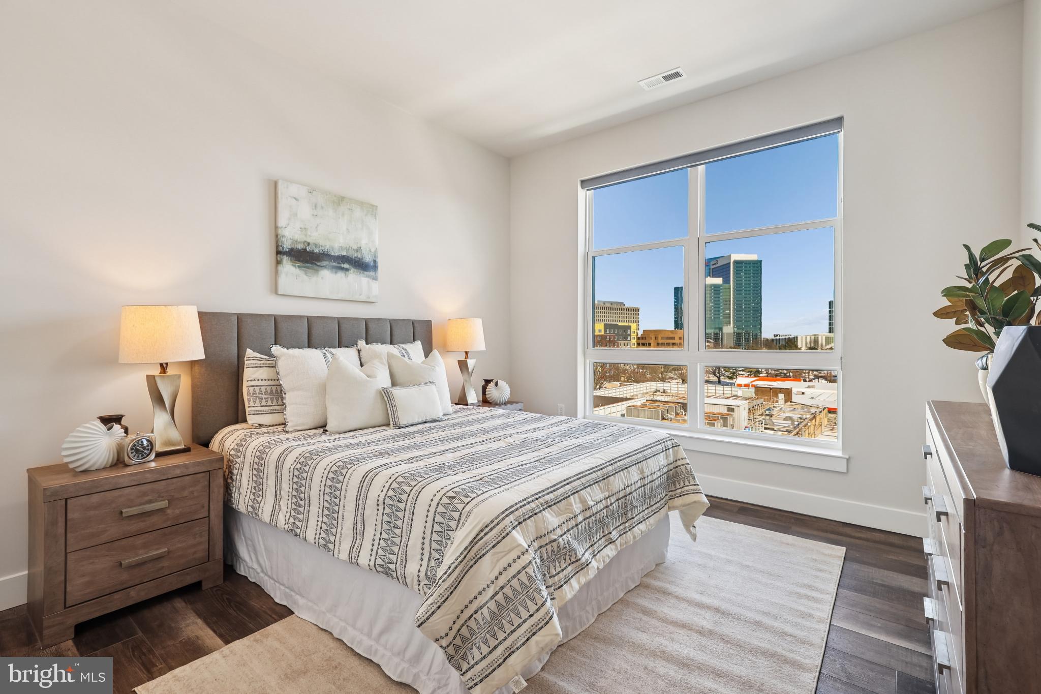 1761 Old Meadow Road, Unit 517 McLean, VA 22102 - Photo 18 of 39 a bedroom with a bed and a lamp on dresser