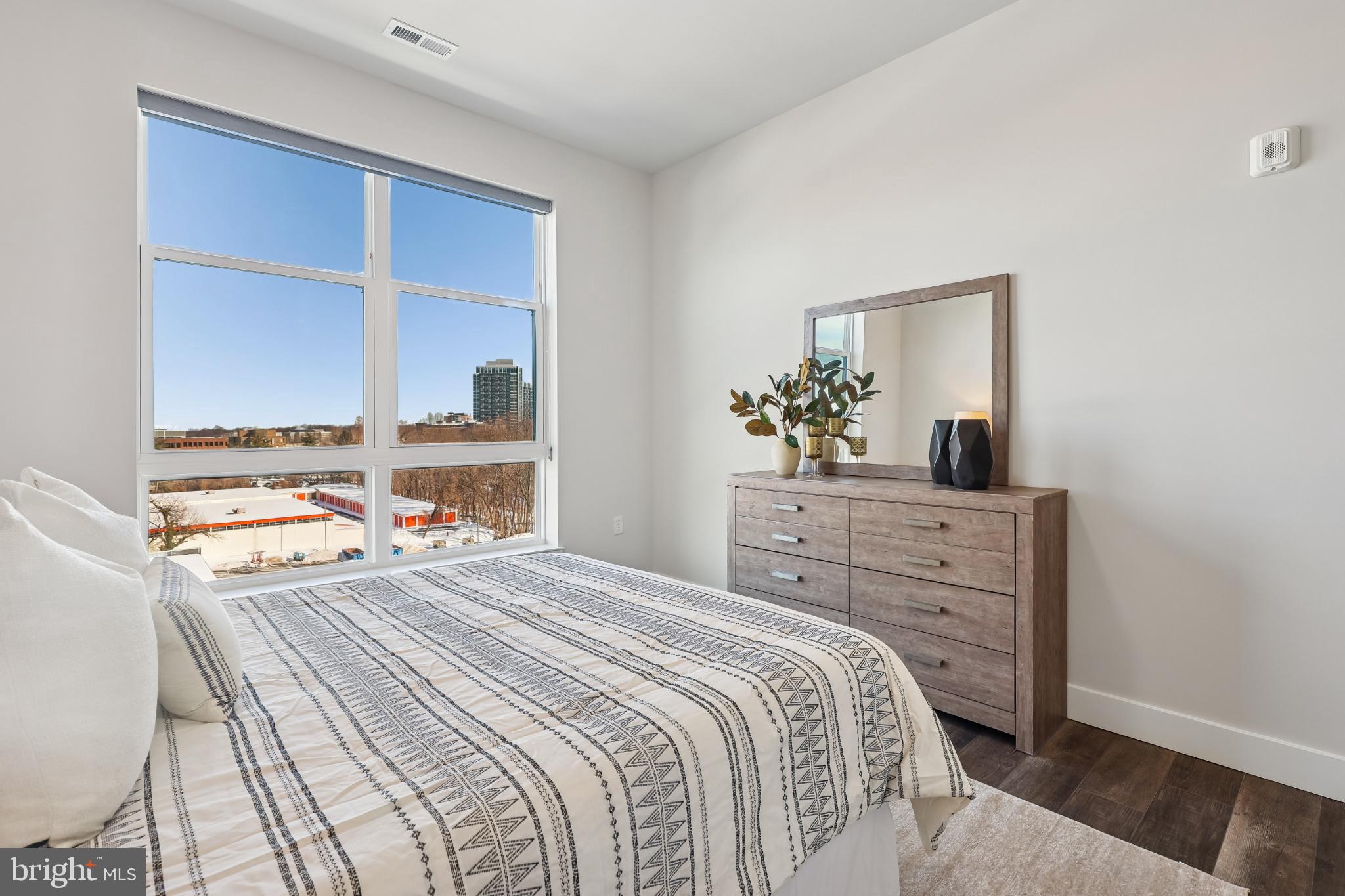 1761 Old Meadow Road, Unit 517 McLean, VA 22102 - Photo 19 of 39 a bedroom with a bed and a dresser