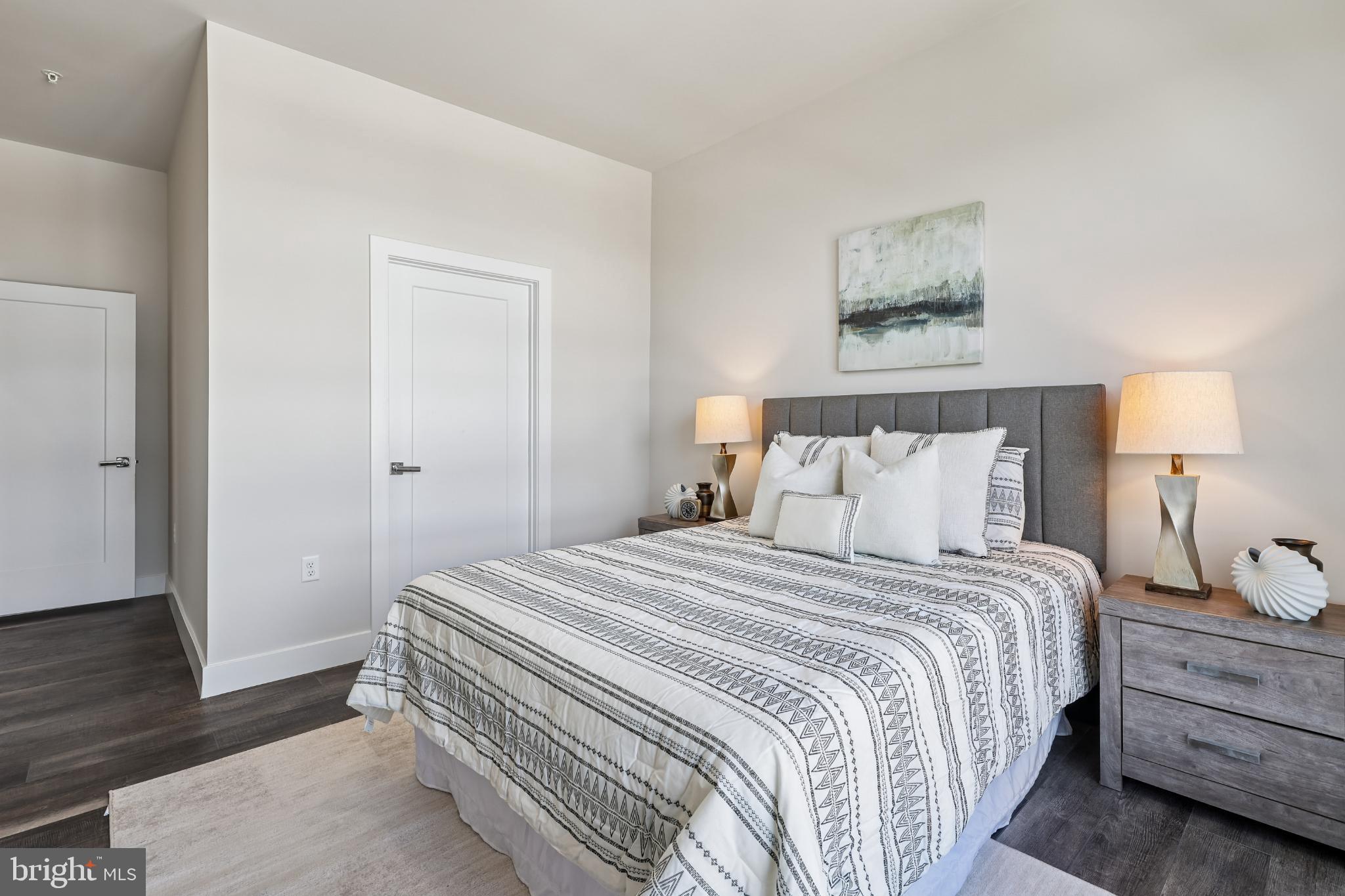 1761 Old Meadow Road, Unit 517 McLean, VA 22102 - Photo 20 of 39 a bedroom with a bed and a lamp on the dresser