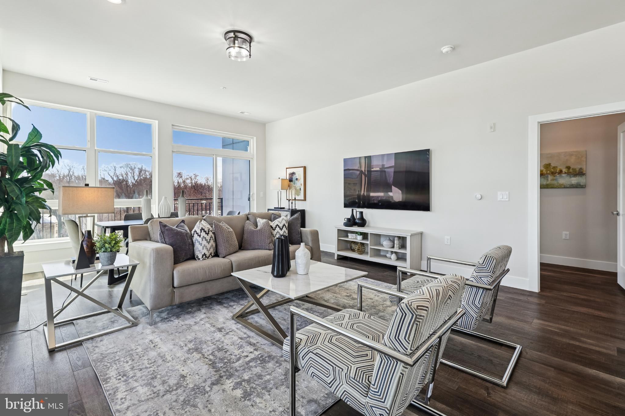1761 Old Meadow Road, Unit 517 McLean, VA 22102 - Photo 2 of 39 a living room with furniture and a flat screen tv