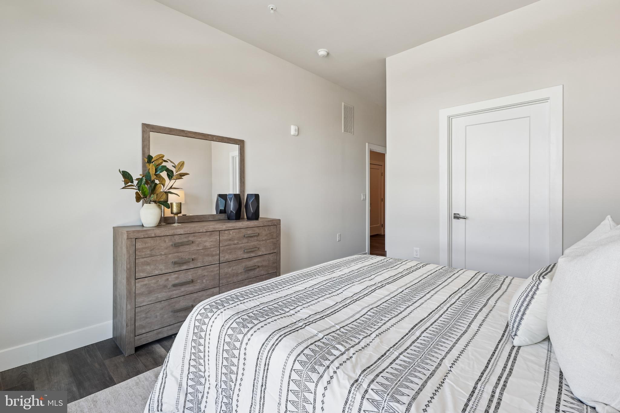 1761 Old Meadow Road, Unit 517 McLean, VA 22102 - Photo 21 of 39 a bedroom with a bed and a dresser
