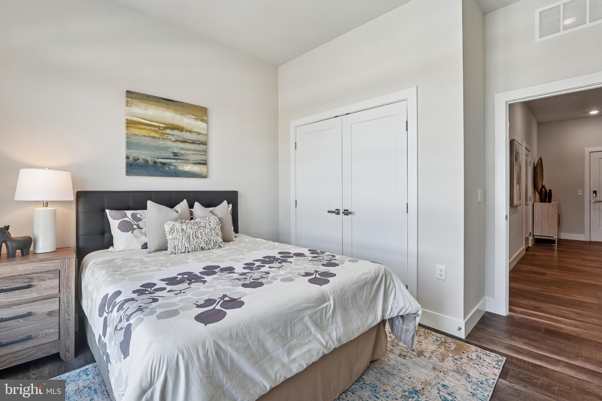 1761 Old Meadow Road, Unit 517 McLean, VA 22102 - Photo 24 of 39 a bedroom with a bed and a walk in closet