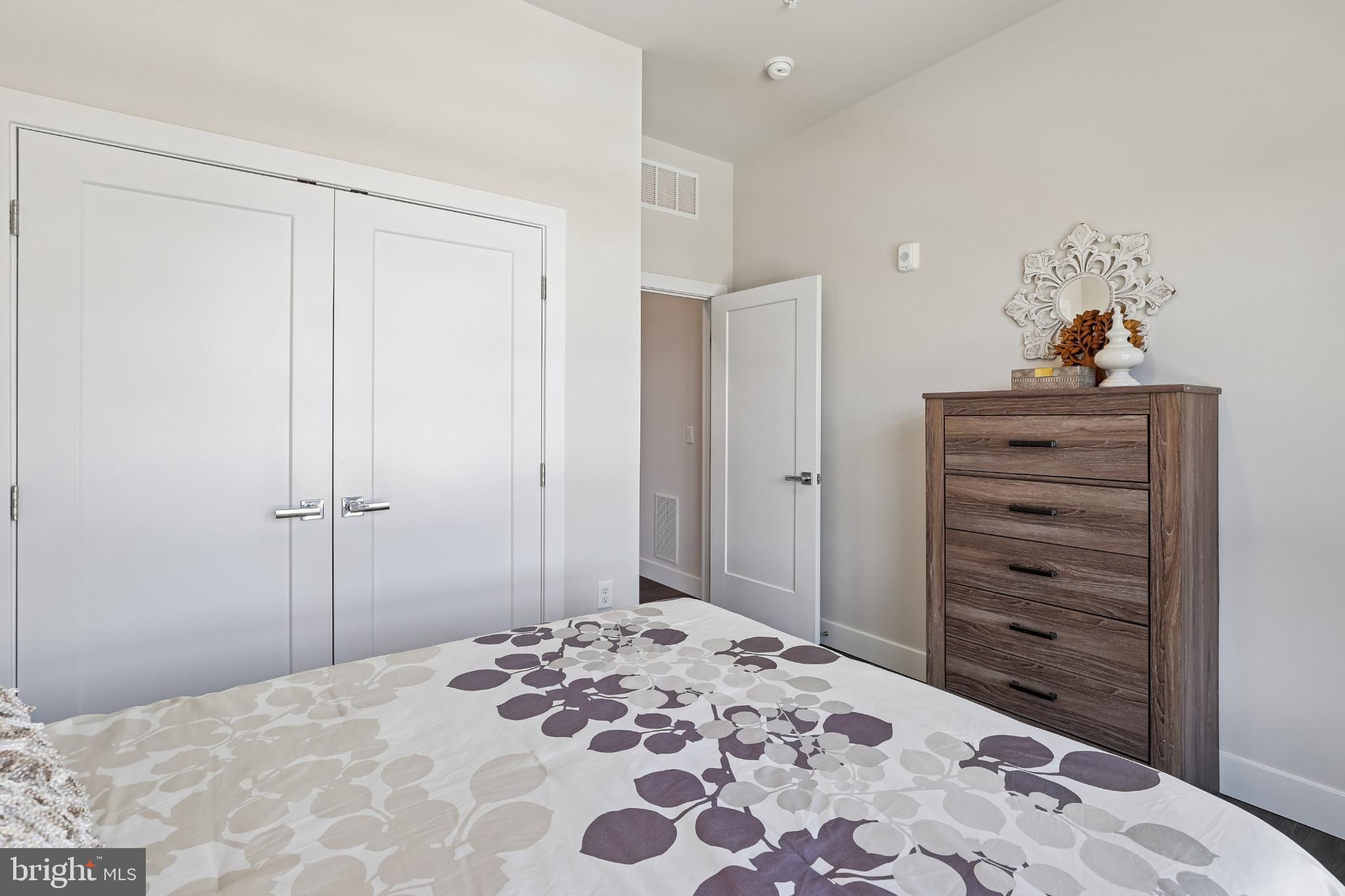 1761 Old Meadow Road, Unit 517 McLean, VA 22102 - Photo 25 of 39 a bedroom with a bed and a mirror