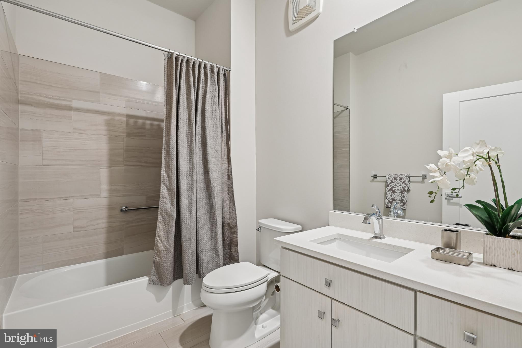 1761 Old Meadow Road, Unit 517 McLean, VA 22102 - Photo 27 of 39 a bathroom with a sink a toilet and shower