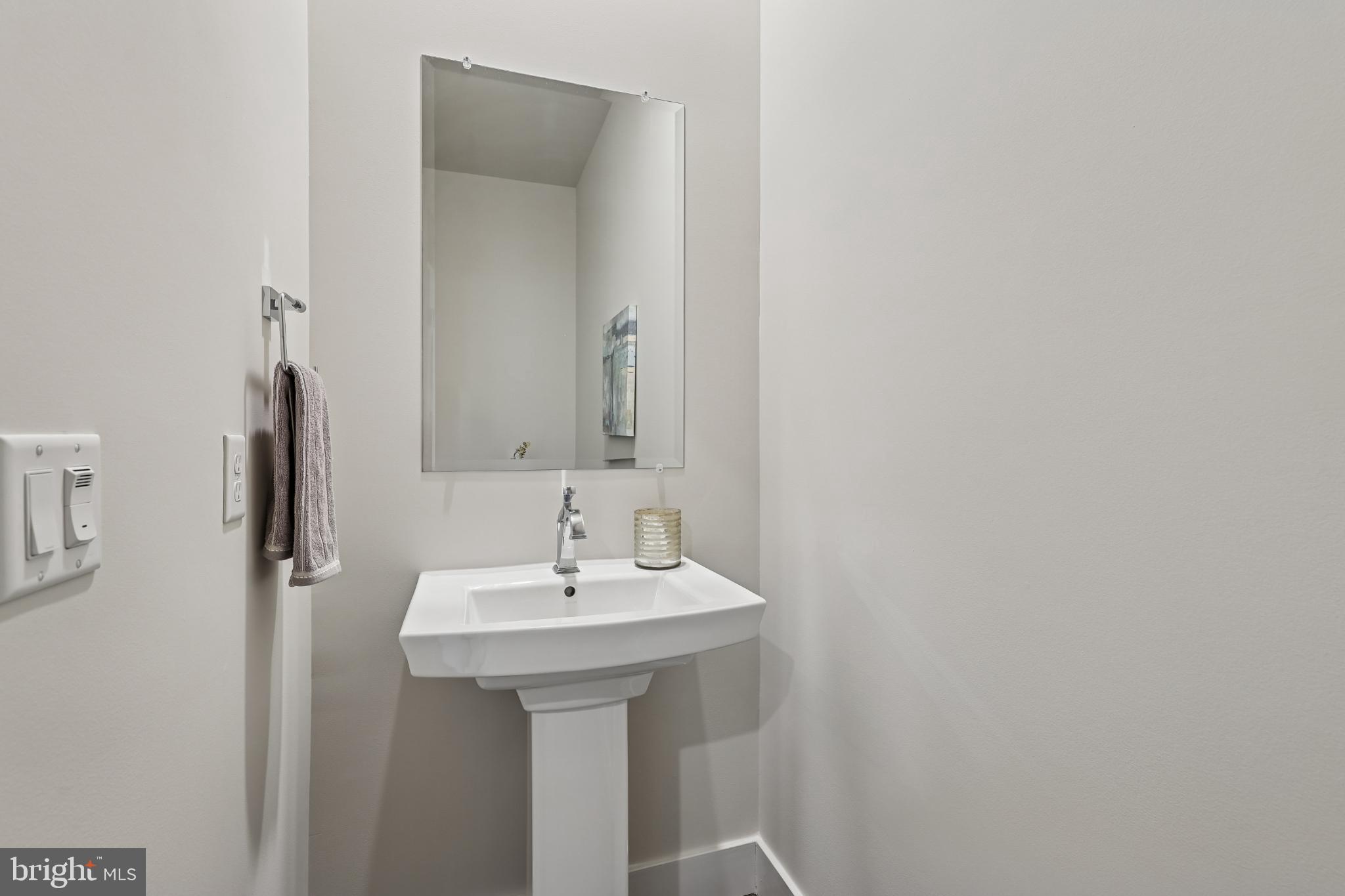 1761 Old Meadow Road, Unit 517 McLean, VA 22102 - Photo 28 of 39 a bathroom with a sink and a mirror