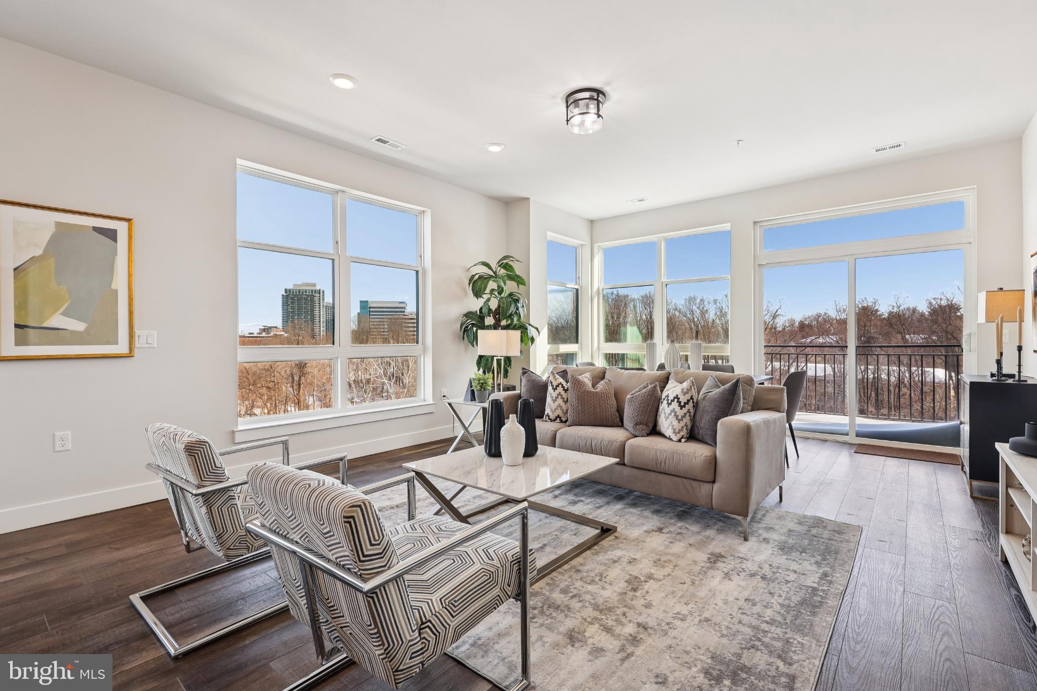 1761 Old Meadow Road, Unit 517 McLean, VA 22102 - Photo 3 of 39 a living room with furniture and a floor to ceiling window