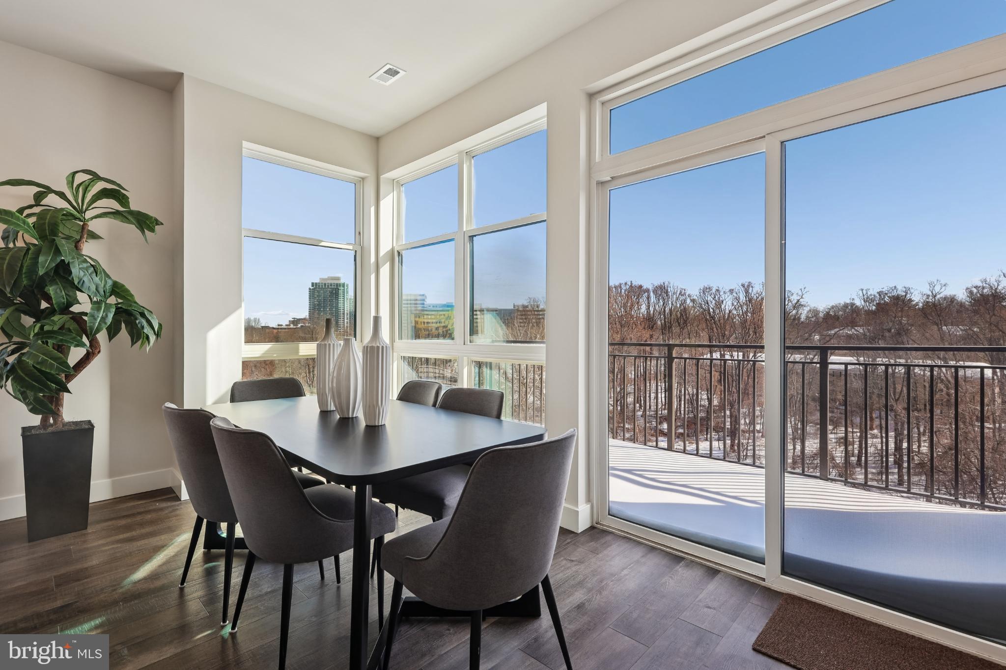 1761 Old Meadow Road, Unit 517 McLean, VA 22102 - Photo 4 of 39 a dining room with furniture window and wooden floor
