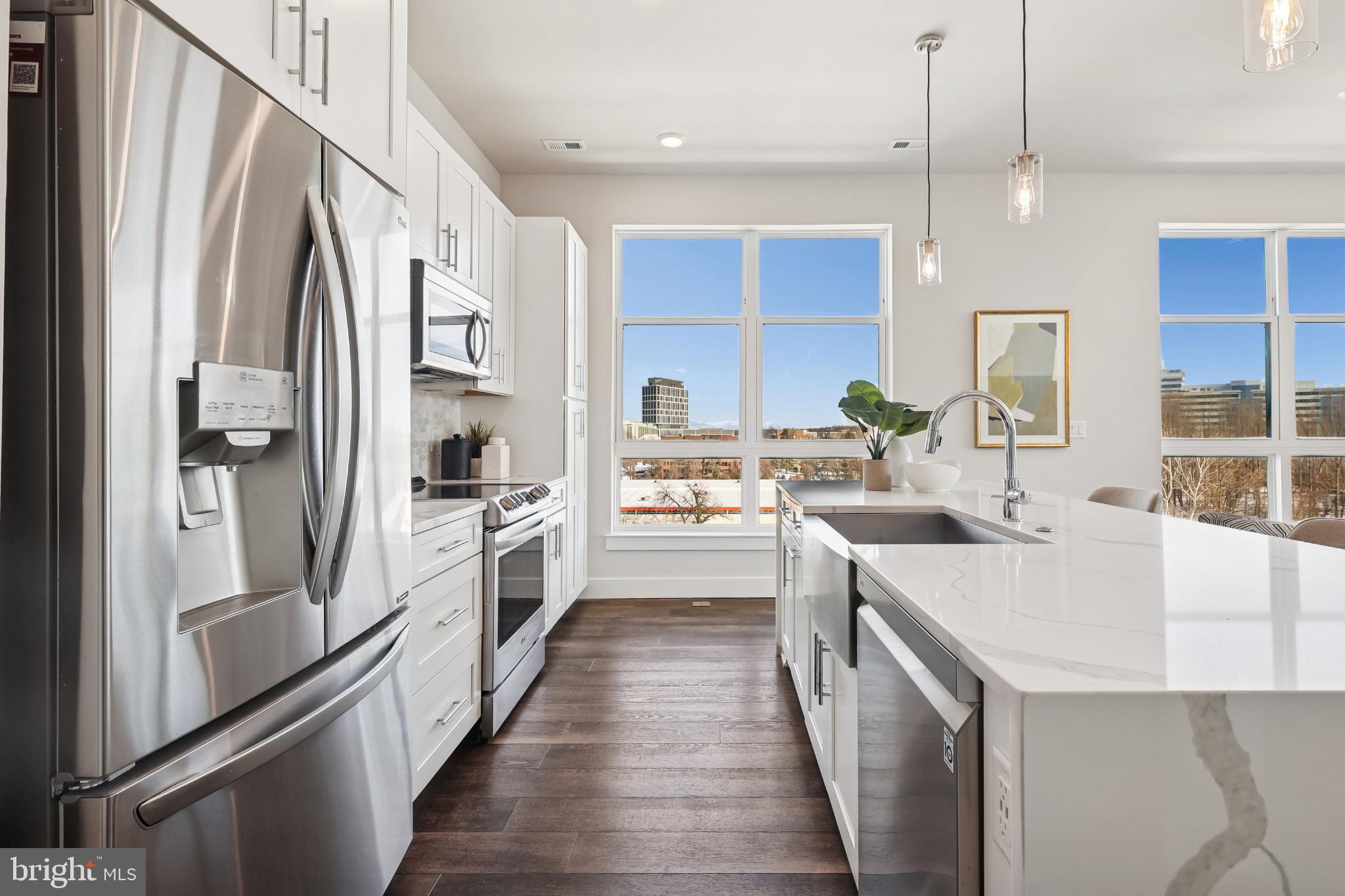 1761 Old Meadow Road, Unit 517 McLean, VA 22102 - Photo 7 of 39 a large kitchen with stainless steel appliances a sink and a refrigerator
