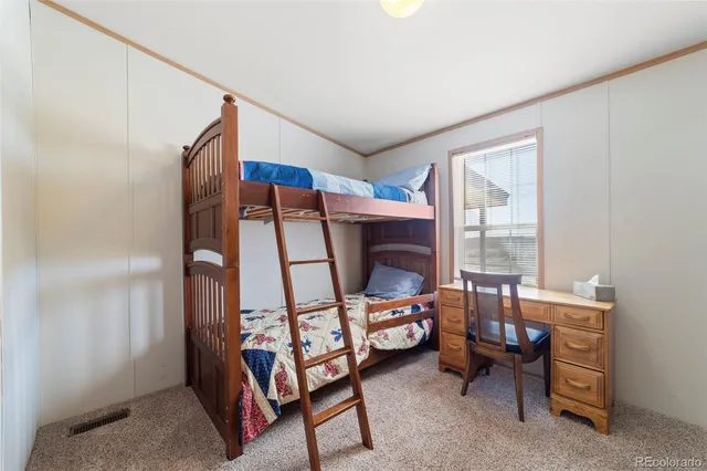 a bedroom with furniture and a window