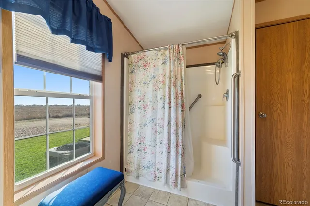 a view of a bathroom with a tub and shower