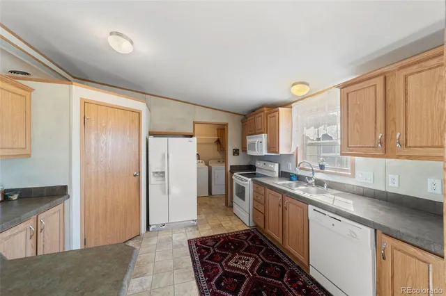 a kitchen with a sink stove and refrigerator