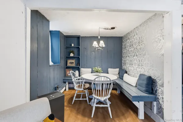 a view of a dining room with furniture and wooden floor