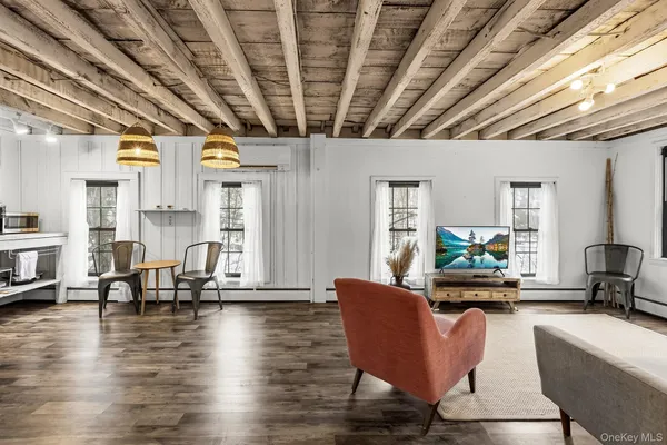 a living room with furniture wooden floor and a chandelier