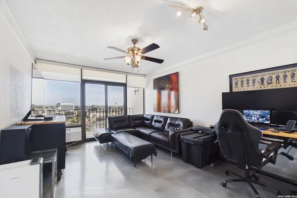a living room with furniture a fireplace and a large window