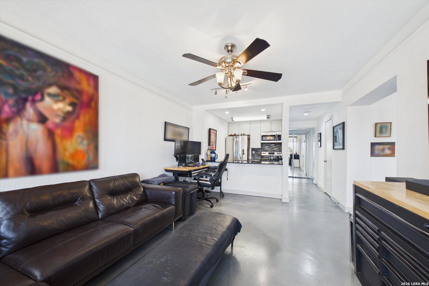7701 Wurzbach Road, Unit 1803 San Antonio, TX 78229 - Photo 13 of 34 a living room with furniture and a flat screen tv