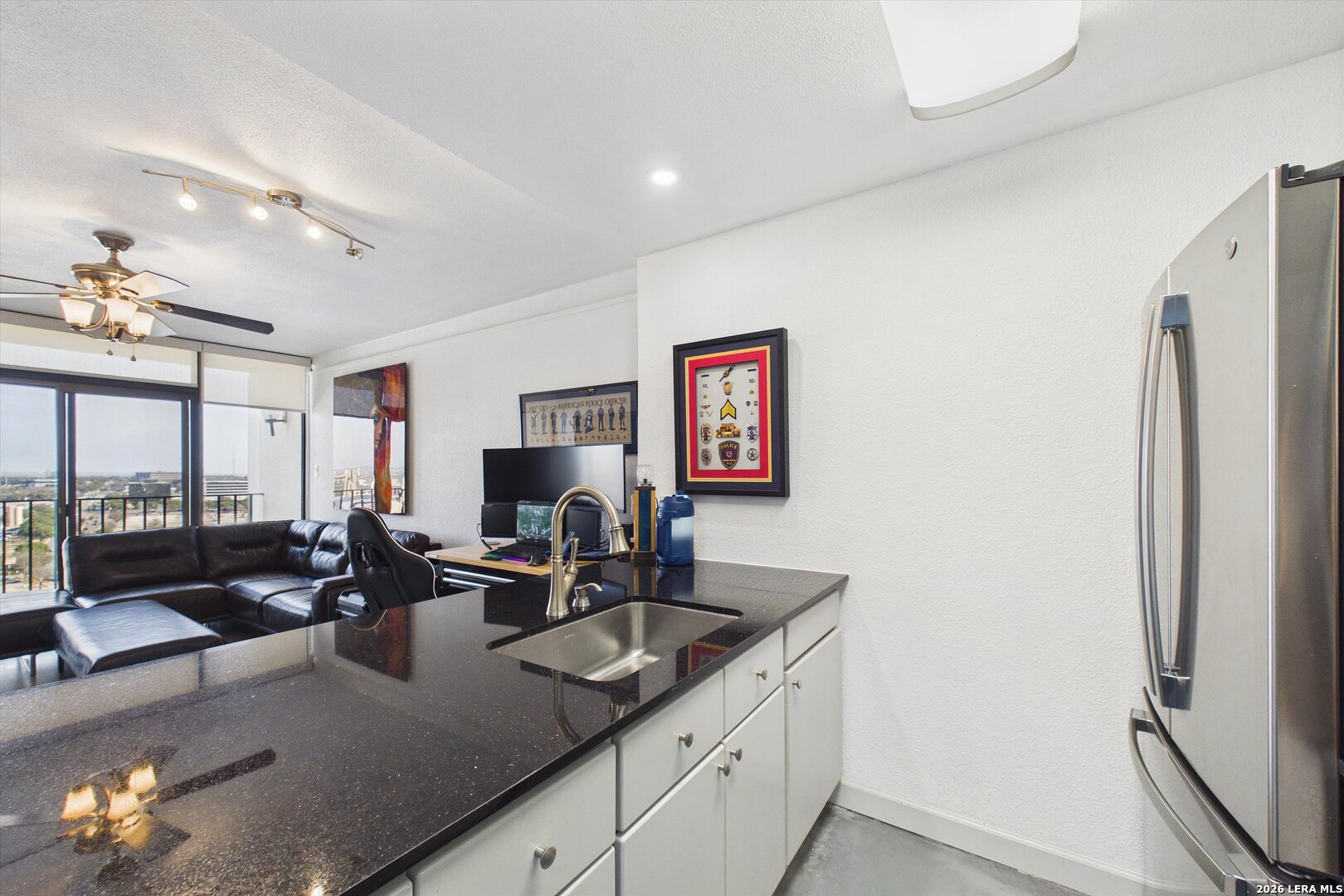 7701 Wurzbach Road, Unit 1803 San Antonio, TX 78229 - Photo 15 of 34 a kitchen with stainless steel appliances granite countertop a sink refrigerator and cabinets