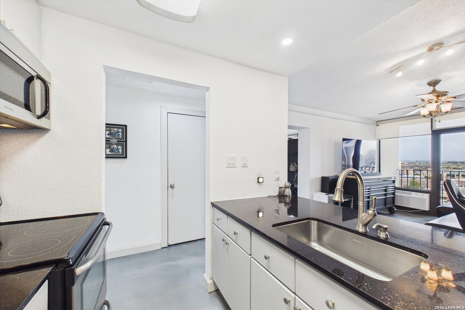 7701 Wurzbach Road, Unit 1803 San Antonio, TX 78229 - Photo 16 of 34 a kitchen with sink and mirror