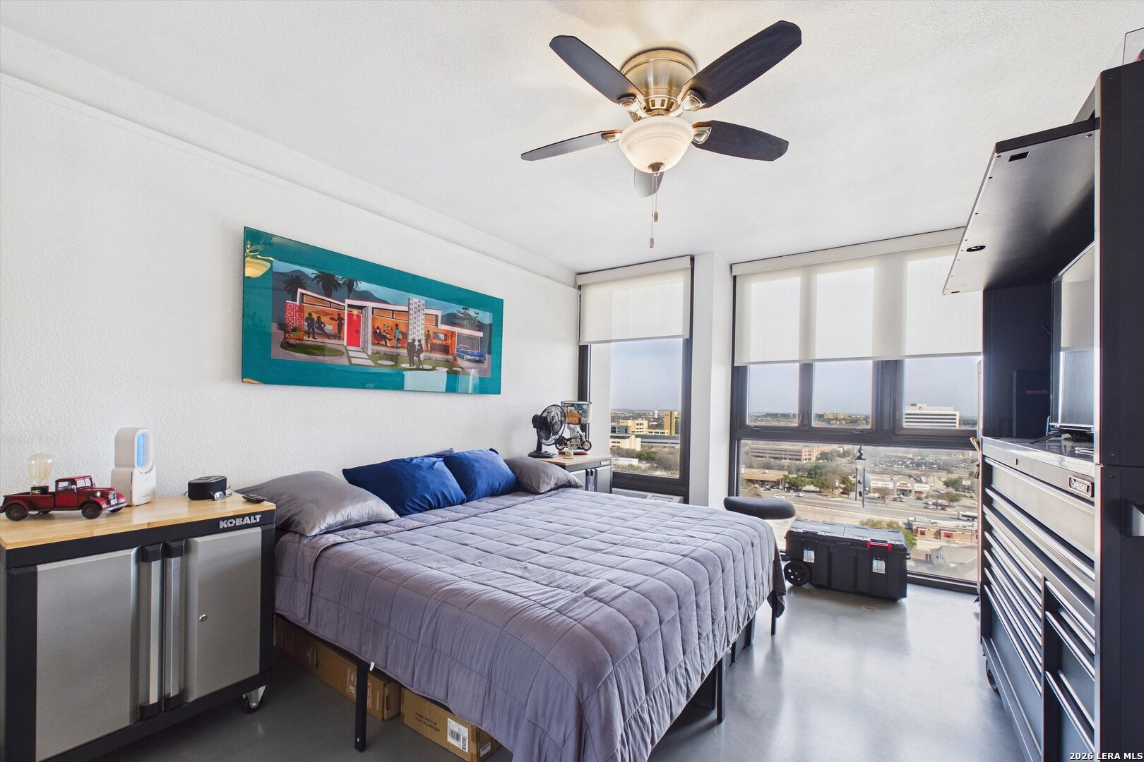 7701 Wurzbach Road, Unit 1803 San Antonio, TX 78229 - Photo 18 of 34 a bedroom with a bed a couch and dresser