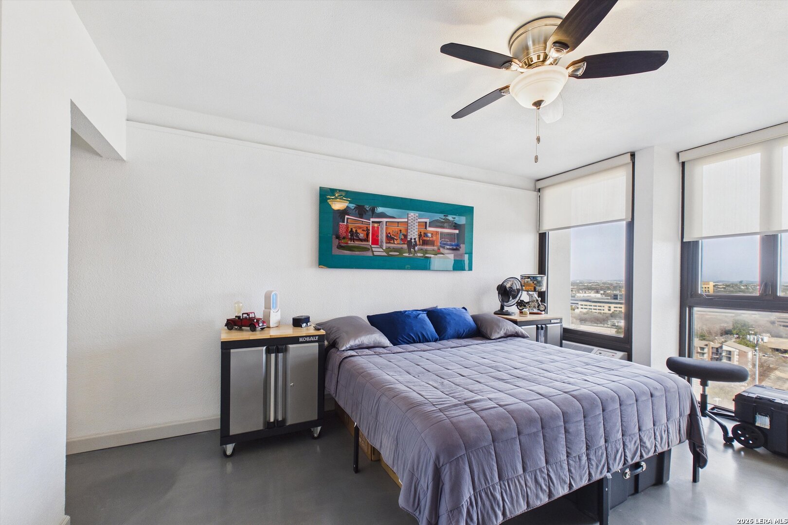 7701 Wurzbach Road, Unit 1803 San Antonio, TX 78229 - Photo 20 of 34 a bedroom with a large bed and a chandelier