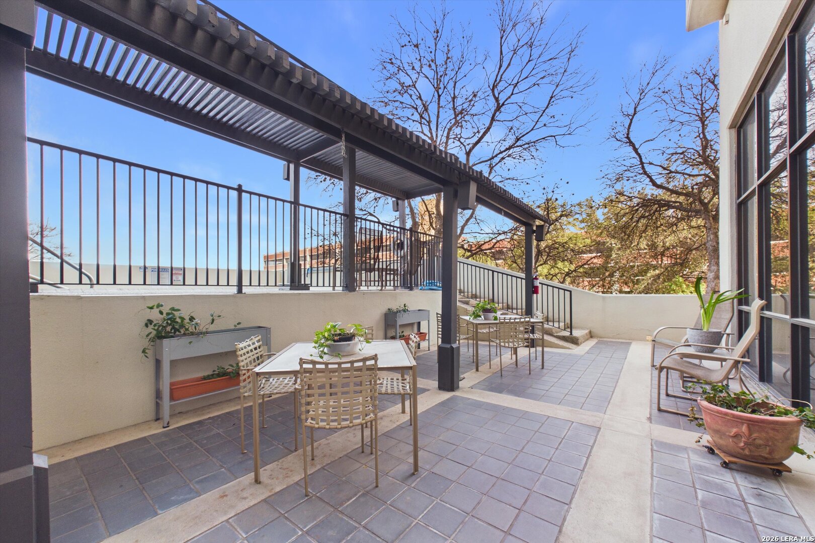 7701 Wurzbach Road, Unit 1803 San Antonio, TX 78229 - Photo 27 of 34 a backyard of a house with outdoor seating