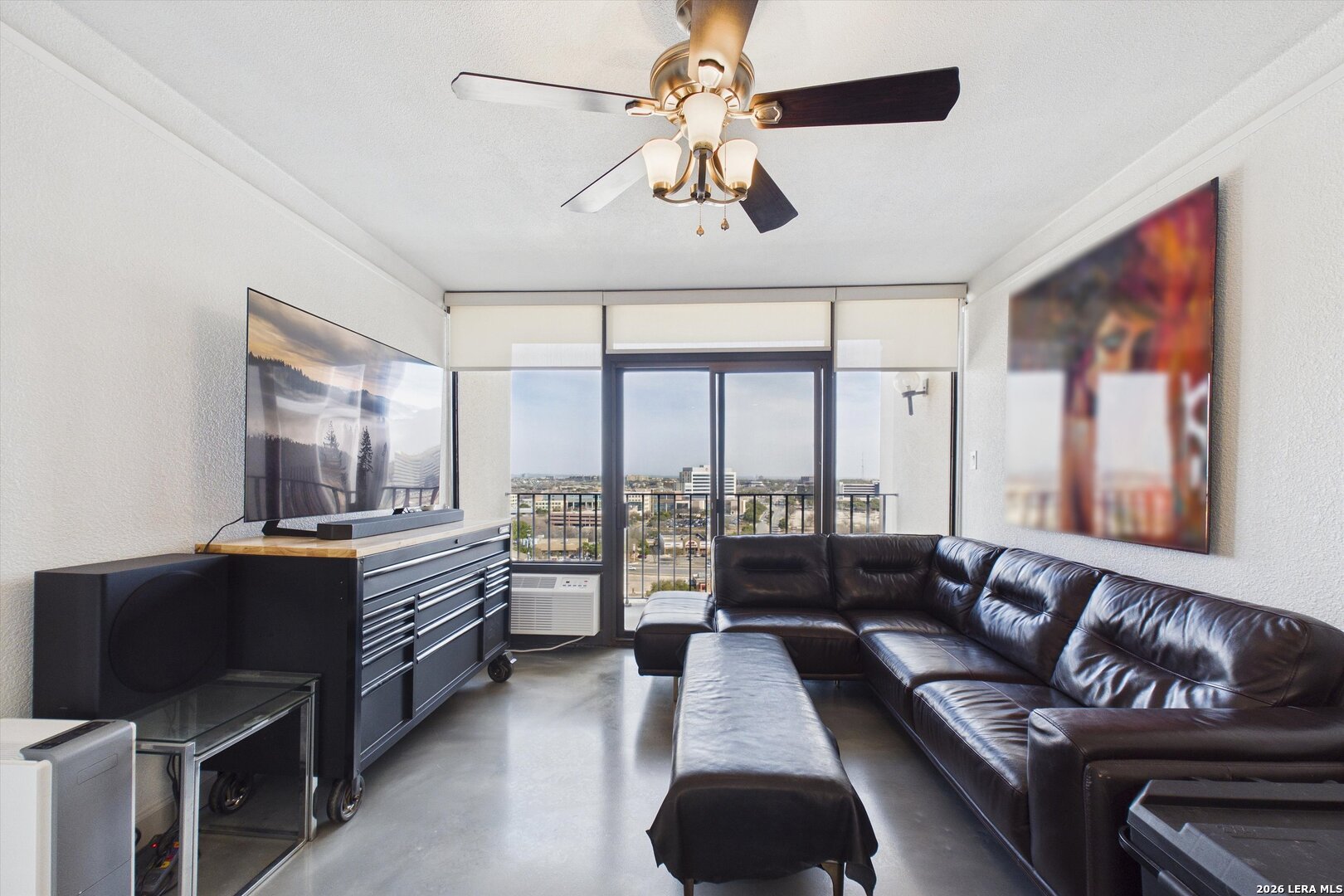7701 Wurzbach Road, Unit 1803 San Antonio, TX 78229 - Photo 10 of 34 a living room with furniture and large windows