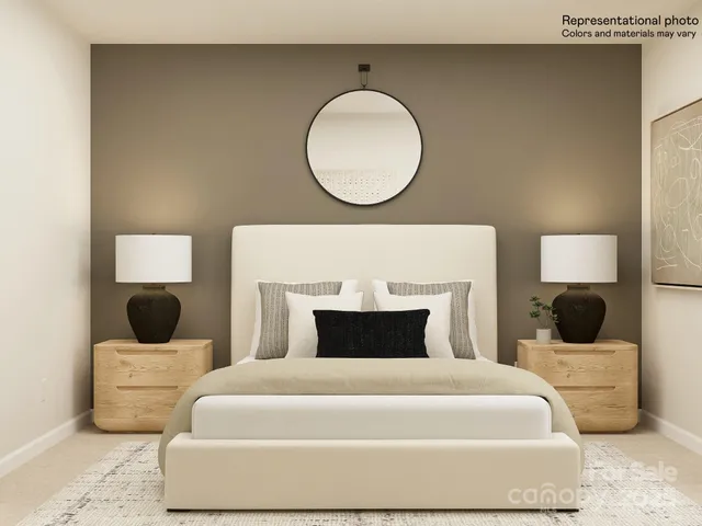 a bedroom with a bed and a lamp