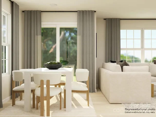 a kitchen with stainless steel appliances a refrigerator a stove a microwave and white cabinets