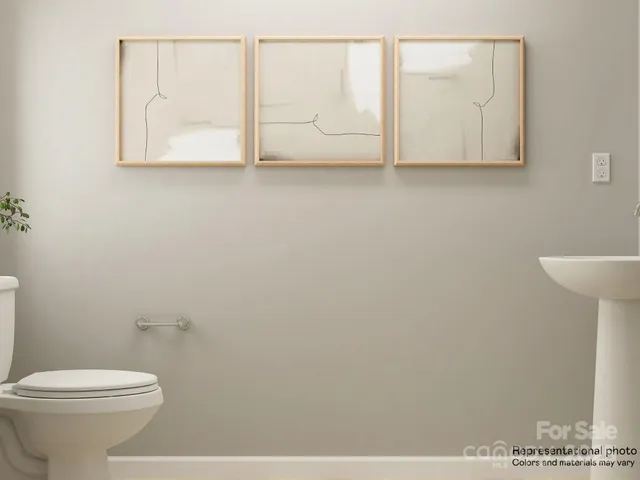 a bedroom with a bed and a lamp on dresser