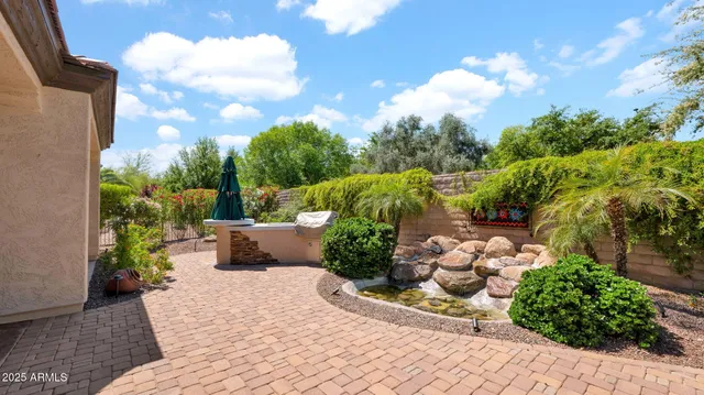 a view of a house with backyard and sitting area