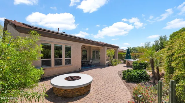 a view of a house with backyard porch and sitting area