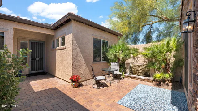 a view of a house with backyard and sitting area