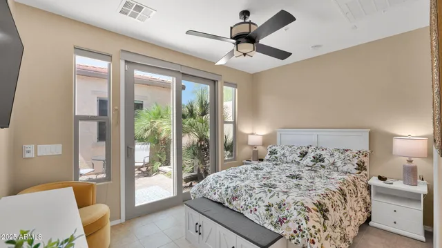 a bedroom with a large bed and a large window