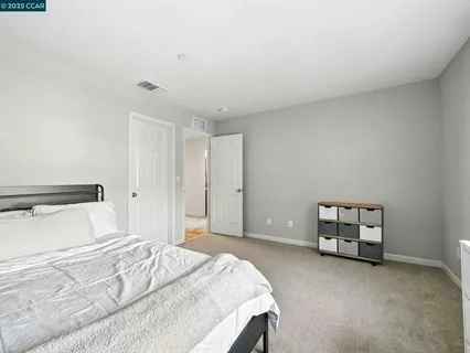 a bedroom with a large bed and white walls