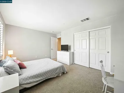 a bedroom with a bed and cabinets