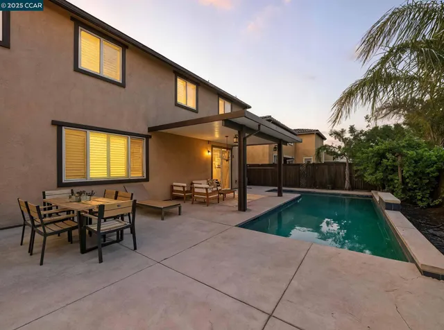 a view of a backyard with swimming pool