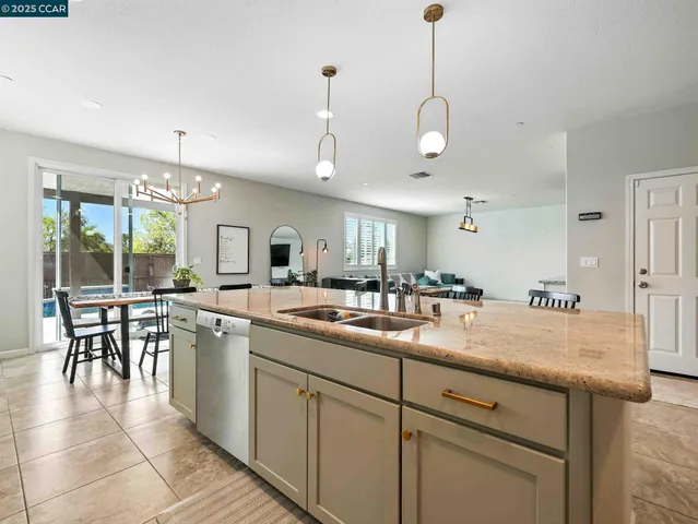 a kitchen with a table chairs and white cabinets