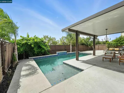 a view of a patio with swimming pool table and chairs
