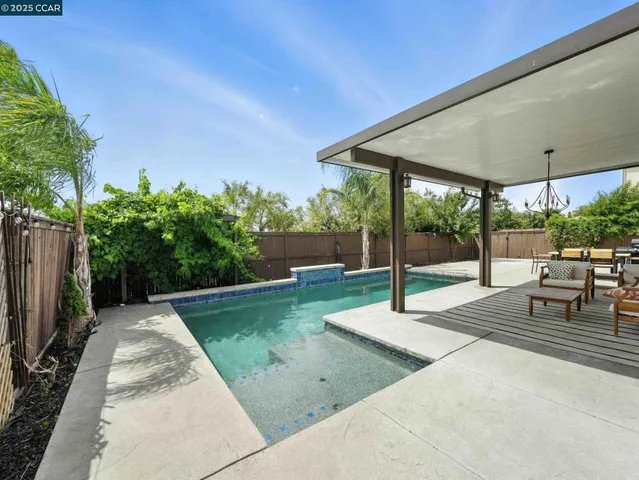 a view of a patio with swimming pool table and chairs
