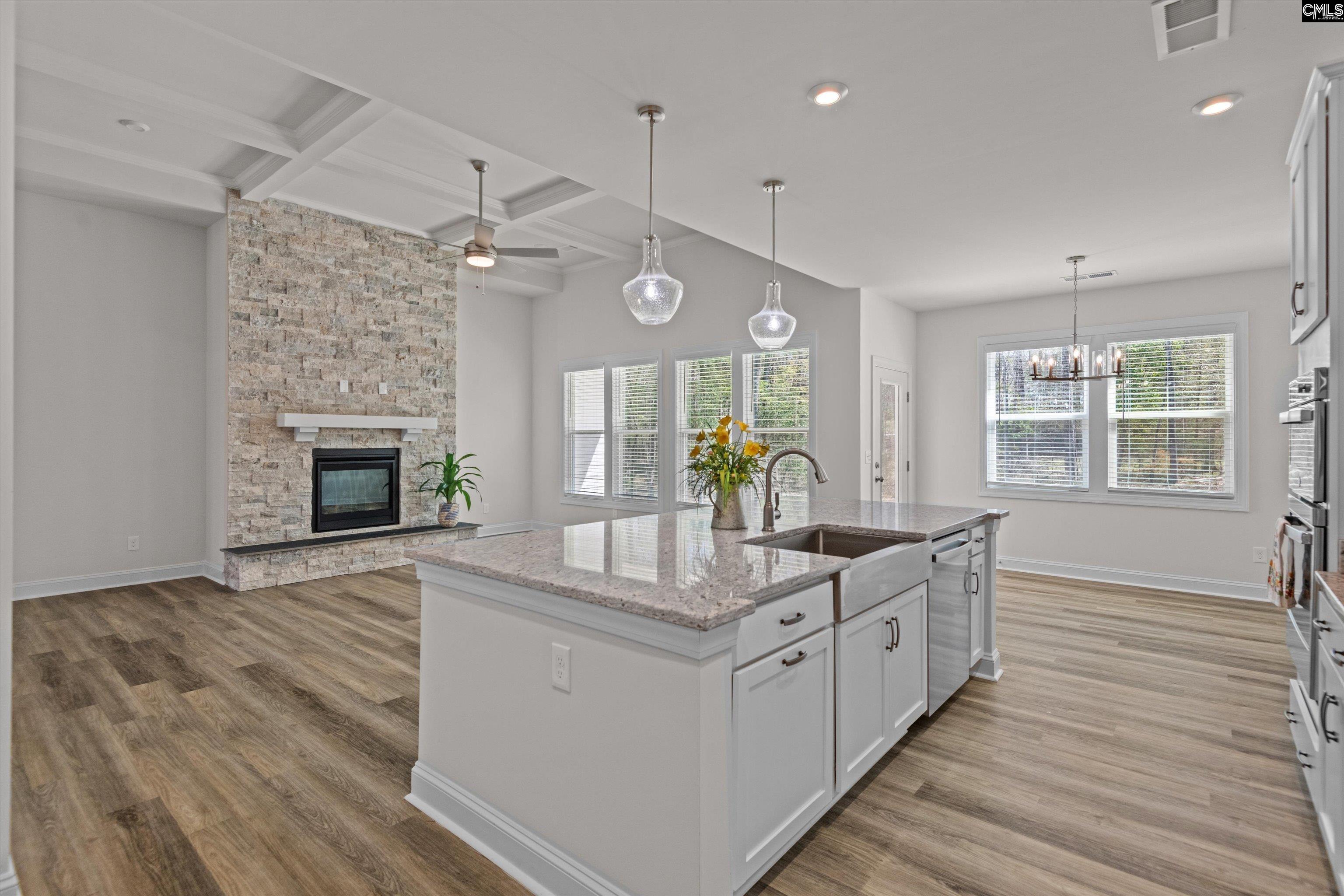 558 Wild Ginger Loop Irmo, SC 29063 - Photo 14 of 42 a kitchen with granite countertop a stove oven and a wooden floors