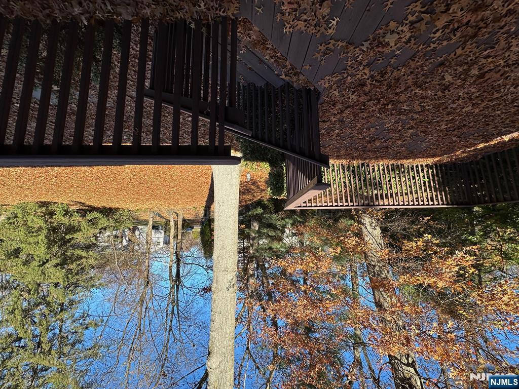 a view of a balcony with wooden fence and floor