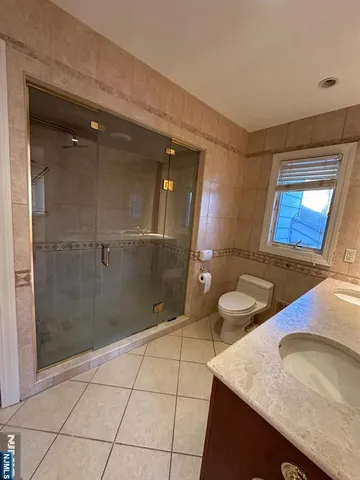 a view of a hallway with wooden floor and closet