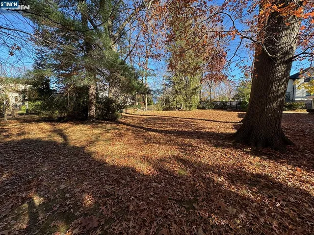 a view of balcony with wooden floor and fence