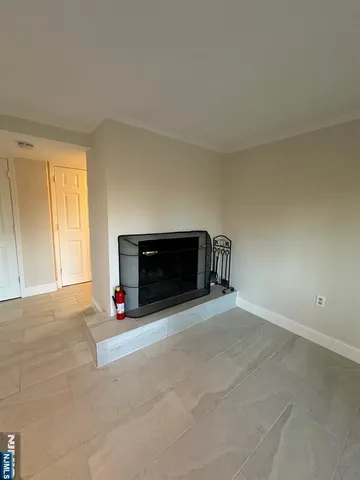 a view of empty room with a fireplace