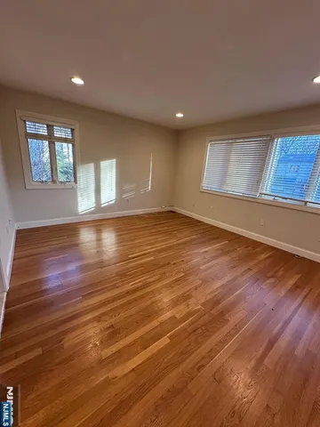 a bathroom with a granite countertop sink a mirror and shower