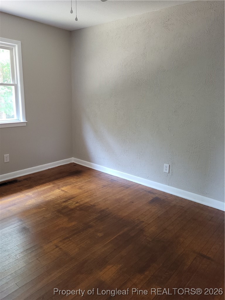 182 Summerhill Road Fayetteville, NC 28303 - Photo 20 of 24 an empty room with wooden floor and windows