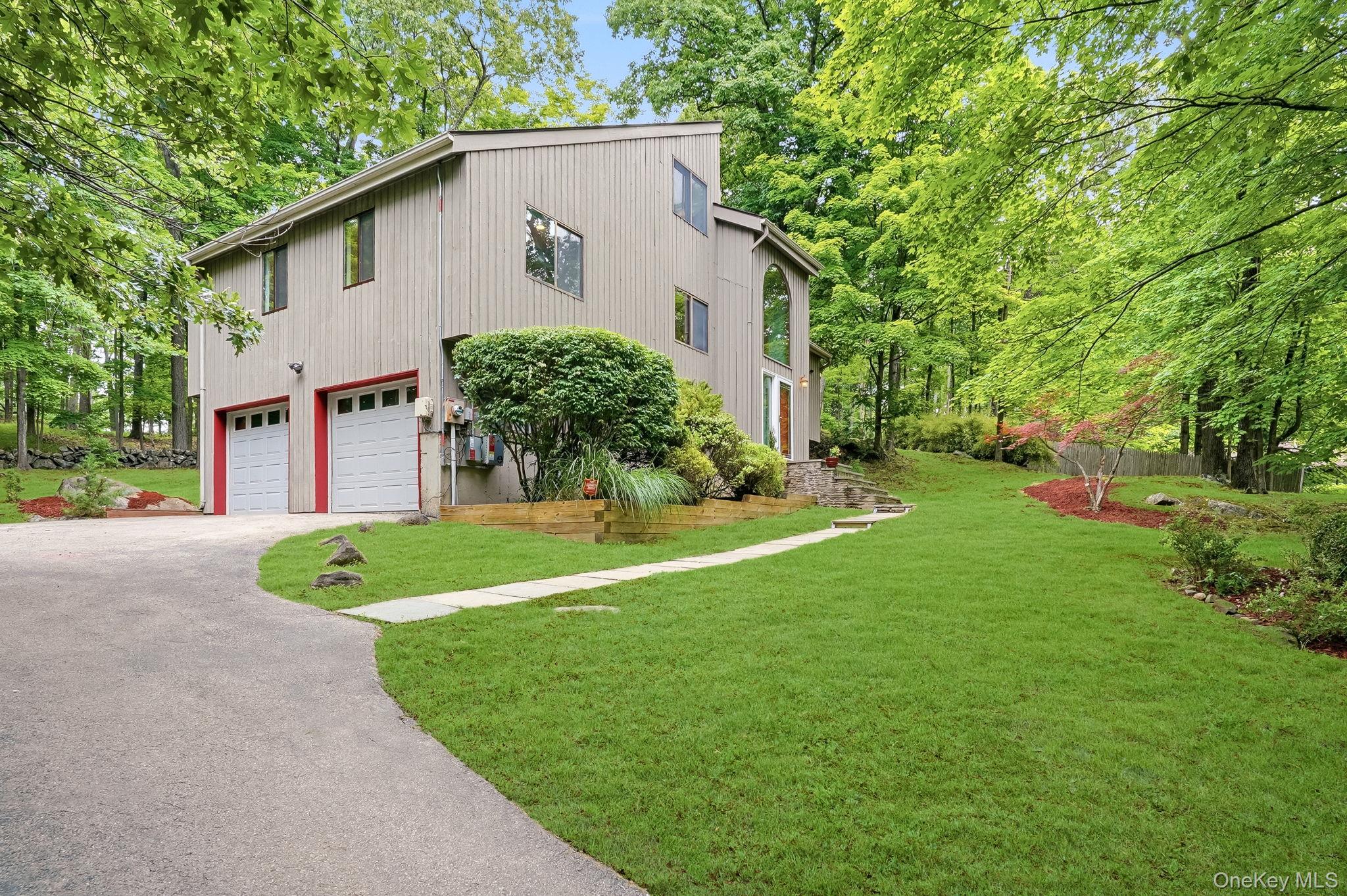 43 Powder Horn Road Cortlandt Manor, NY 10567 - Photo 2 of 35 View of the attached 2-car garage and side yard