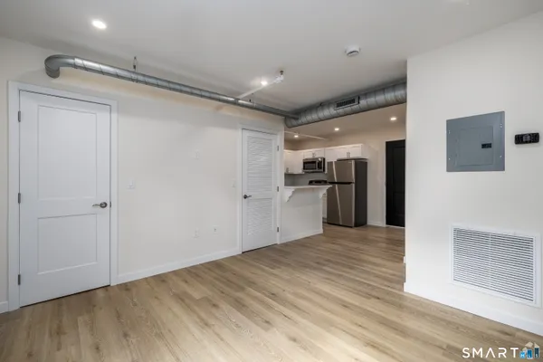 a view of empty room with wooden floor